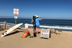 Two people look out at the shore after a reported shark attack at Newcomb Hollow Beach in Wellfleet, Mass, on Saturday, Sept. 15, 2018. A man boogie boarding off the Cape Cod beach was attacked by a shark on Saturday and died later at a hospital, becoming the state’s first shark attack fatality in more than 80 years.