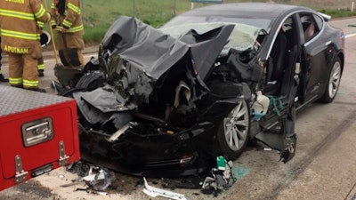 In this May 11, 2018, file photo, released by the South Jordan Police Department shows a traffic collision involving a Tesla Model S sedan with a fire department mechanic truck stopped at a red light in South Jordan, Utah. Heather Lommatzsch, the Utah driver who slammed her Tesla into the stopped firetruck at a red light while using the vehicle's semi-autonomous function, is suing the company.