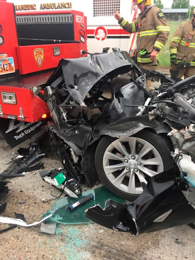 In this May 11, 2018, file photo, released by the South Jordan Police Department shows a traffic collision involving a Tesla Model S sedan with a fire department mechanic truck stopped at a red light in South Jordan, Utah. Heather Lommatzsch, the Utah driver who slammed her Tesla into the stopped firetruck at a red light while using the vehicle's semi-autonomous function, is suing the company.