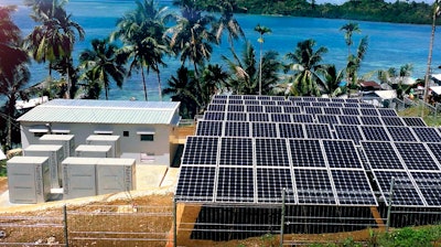 This undated product image provided by NantEnergy shows zinc-air batteries in cabinets at left in a village in Papua, Indonesia. California-based NantEnergy said Wednesday, Sept. 26, 2018, that it has created a rechargeable zinc-air battery storage system that can provide power at a lower cost than lithium-ion systems.