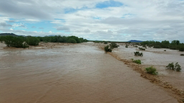 Flooding near the Kohatk Village in Pinal County, Arizona. Menagers Dam that had been at risk of breaking and flooding the small village held steady Wednesday, Oct. 3, as the lake behind it receded after being swollen with runoff from the remnants of Tropical Storm Rosa.