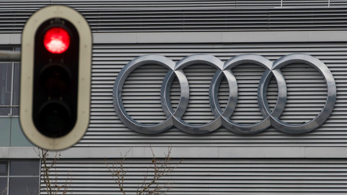 In this Wednesday, March 15, 2017 photo a traffic sign shows a red light in front of the Audi headquarters in Ingolstadt, Germany. Audi accepted a fine of 800 million euro (927 million US$) for it's involvement in the Diesel scandal.