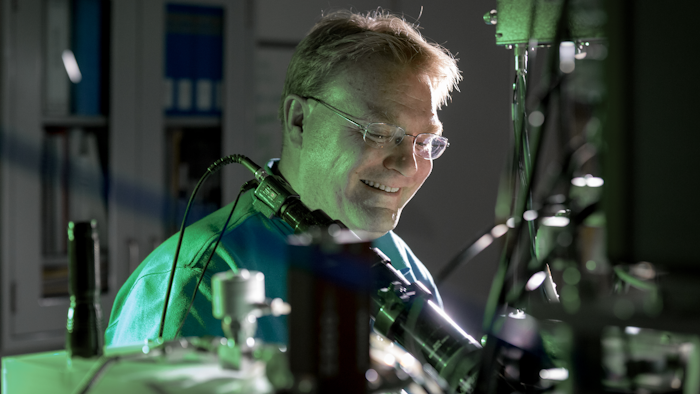 Sandia National Laboratories’ Ed Bielejec examines a material at the Ion Beam Laboratory with the Nano-Implanter, a machine that produces very precise material defects. A smaller, lower voltage version will enable Bielejec and his team to do the same for advanced materials that could be used in semiconductors and other applications.