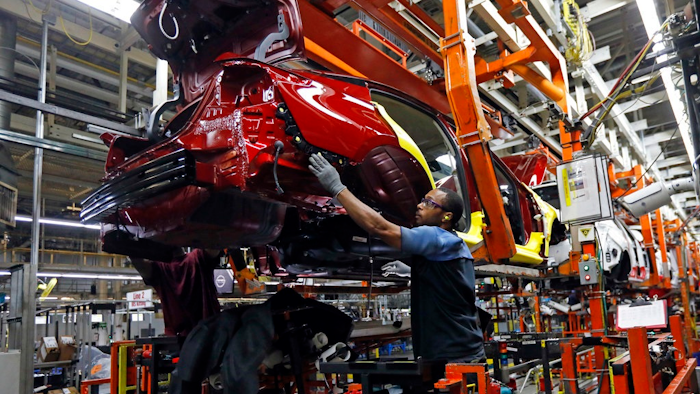In this Sept. 27, 2018, file photo line technicians work on assembling a redesigned Nissan Altima sedan at its Nissan Canton Vehicle Assembly Plant in Canton, Miss. On Tuesday, Oct. 16, the Federal Reserve reports on U.S. industrial production for September.