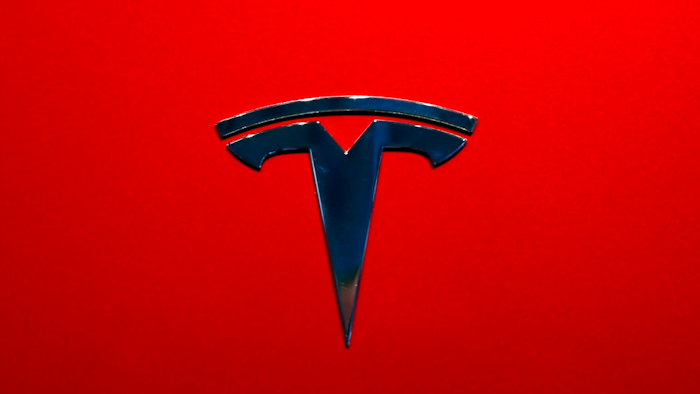 This Oct. 3, 2018, file photo shows the logo of Tesla model 3 at the Auto show in Paris. Tesla Inc. reports earnings on Wednesday, Oct. 24.