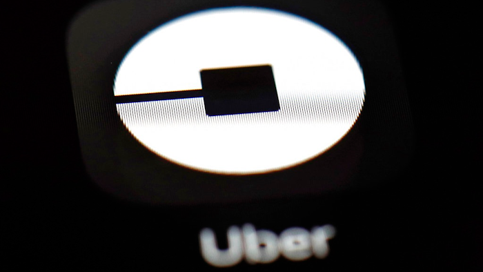 This March 20, 2018, file photo shows the Uber app on an iPad in Baltimore. Uber may put forth an initial public offering early next year that values the ride-hailing business at as much as $120 billion, according to a media report. The Wall Street Journal said Tuesday, Oct. 16, that Uber Technologies Inc. received valuation proposals from Goldman Sachs and Morgan Stanley.