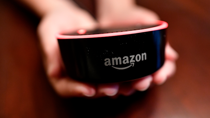 In this Aug. 16, 2018, file photo a child holds his Amazon Echo Dot in Kennesaw, Ga. Amazon.com Inc. reports earnings Thursday, Oct. 25.
