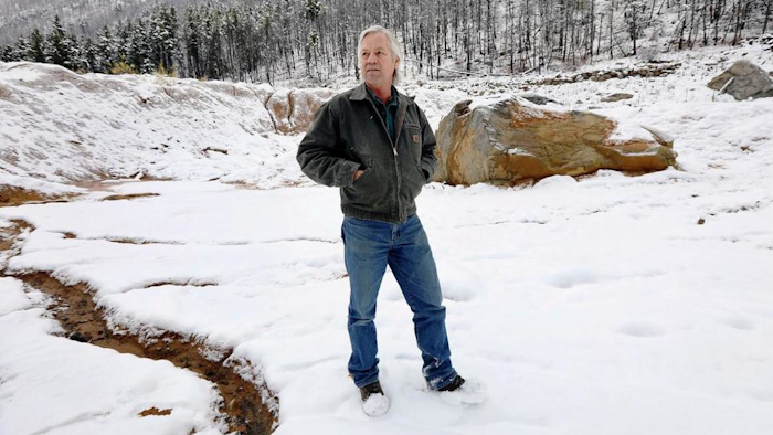 In this Oct. 11, 2018 photo, Paule Antonioli, an independent miner from Butte, stands among tailing piles at his Mammoth Mine south of Cardwell, Mont. in the Tobacco Root Mountains. Through a program that began in 2011, Barrick Gold Corp.-owned Golden Sunlight has paid out more than $45 million to small miners in the last seven years, company officials say. All of it has been for gold dug out of old mine dumps.
