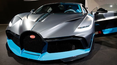 A Bugatti Divo is on display at the Auto show in Paris, France, Wednesday, Oct. 3, 2018, 2018. All-electric vehicles with zero local emissions are among the stars of the Paris auto show, rubbing shoulders with the fossil-fuel burning SUVs that many car buyers love.