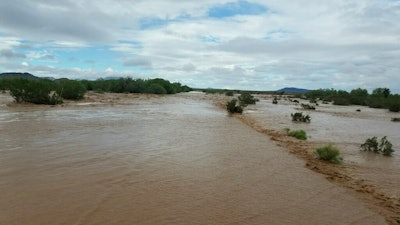 Flooding near the Kohatk Village in Pinal County, Arizona. Menagers Dam that had been at risk of breaking and flooding the small village held steady Wednesday, Oct. 3, as the lake behind it receded after being swollen with runoff from the remnants of Tropical Storm Rosa.