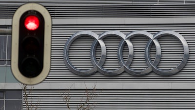 In this Wednesday, March 15, 2017 photo a traffic sign shows a red light in front of the Audi headquarters in Ingolstadt, Germany. Audi accepted a fine of 800 million euro (927 million US$) for it's involvement in the Diesel scandal.