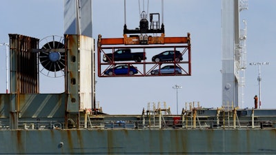 In this July 13, 2017, file photo, a crane transporting vehicles operates on a container ship at the Port of Oakland, in Oakland, Calif. Vehicle sales are slowing down despite a run on big SUVs. Major automakers said Tuesday, Oct. 2, 2018, that U.S. sales fell 7 percent in September and 4 percent for the June-through-September quarter, compared with the same periods last year.
