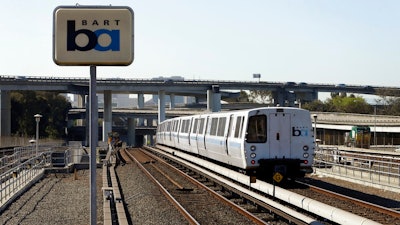 In this Oct. 15, 2013 file photo, a Bay Area Rapid Transit train leaves the station in Oakland, Calif. Regulators fined a Northern California transit agency $650,000 for safety failures that led to a train fatally striking two workers inspecting track five years ago during a union strike.