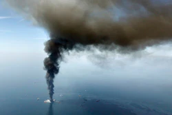 This April 21, 2010, file photo, shows a large plume of smoke rising from BP's Deepwater Horizon offshore oil rig in the Gulf of Mexico. Officials say more than $100 million from a settlement after the 2010 spill has been spent on restoring Texas coastal habitat.