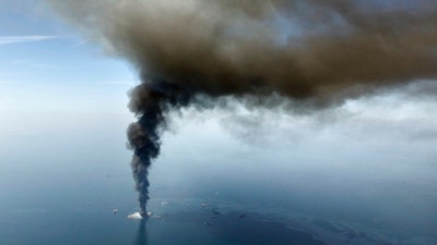 This April 21, 2010, file photo, shows a large plume of smoke rising from BP's Deepwater Horizon offshore oil rig in the Gulf of Mexico. Officials say more than $100 million from a settlement after the 2010 spill has been spent on restoring Texas coastal habitat.
