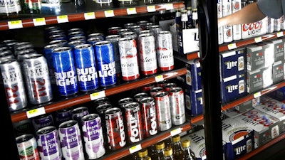This Wednesday, April 19, 2017 file photo shows the beer cooler behind the counter in a convenience store in Sheridan, Ind. In future sweltering years with a double whammy of heat and drought, losses of barley yield can be as much as 17 percent, computer simulations show. And that means “beer prices would, on average, double,” even adjusting for inflation, said a study published in the journal Nature Plants on Wednesday, Oct. 17, 2018.