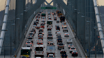 In this Dec. 10, 2015 file photo, vehicles make their way westbound on Interstate 80 across the San Francisco-Oakland Bay Bridge as seen from Treasure Island in San Francisco. California is telling automakers they must still comply with the state's strict vehicle mileage standards even if President Donald Trump rolls them back. The action Friday, Sept. 28, 2018, by the California Air Resources Board was widely expected. It sets up likely court battle if the Trump administration follows through with an attempt to revoke California's unique authority to set its own vehicle emissions standards.