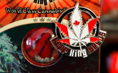 In this Sept. 24, 2018 photo, a pin promoting Crop King Seeds, with the colors and maple-leaf logo of the Canadian flag, is displayed on a package of marijuana seeds for sale at the Warmland Centre, a medical marijuana dispensary in Mill Bay, British Columbia, on Vancouver Island in Canada. On Oct. 17, 2018, Canada will become the second and largest country with a legal national marijuana marketplace.