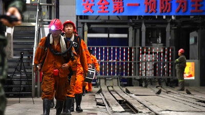 In this photo taken Oct. 21, 2018 and released by Xinhua News Agency, rescuers walk out of the site of a coal mine where falling rocks killed miners and trapped some in Yuncheng County in eastern China's Shandong Province. Emergency crews were struggling Tuesday to rescue 18 coal miners trapped underground in eastern China following a collapse inside the shaft three days earlier.