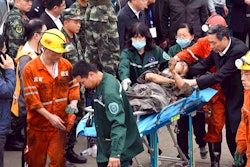 In this photo released by China's Xinhua News Agency, a worker is carried on a stretcher out of the Longyun coal mine in Yuncheng County, east China's Shandong Province, Sunday, Oct. 21, 2018. Twenty were trapped in the coal mine Sunday after a rock burst destroyed part of a mining tunnel.