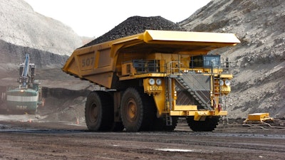 In this April 4, 2013, file photo, a mining dumper truck hauls coal at Cloud Peak Energy's Spring Creek strip mine near Decker, Mont. The Trump administration is considering using West Coast military bases or other federal properties as transit points for shipments of U.S. coal and natural gas to Asia.
