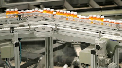 In this July 10, 2018, file photo bottles of medicine ride on a belt at the Express Scripts mail-in pharmacy warehouse in Florence, N.J. On Monday, Oct. 15, the industry's largest trade group announced that dozens of drugmakers will start disclosing the prices for U.S. prescription drugs advertised on TV. The prices won't actually be shown in the TV commercials but the advertisement will include a website where the list price will be posted.