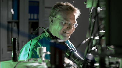 Sandia National Laboratories’ Ed Bielejec examines a material at the Ion Beam Laboratory with the Nano-Implanter, a machine that produces very precise material defects. A smaller, lower voltage version will enable Bielejec and his team to do the same for advanced materials that could be used in semiconductors and other applications.