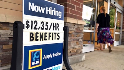 In this July 17, 2018, file photo, a sign outside a business in Salem, N.H. says 'Now Hiring.' On Tuesday, Oct. 16, the Labor Department reports on job openings and labor turnover for August.