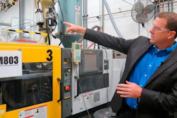 In this Wednesday, Sept. 12, 2018, photo, Paul Buzzell points to a machine used to make the levels that Johnson Level and Tool manufactures, in Mequon, Wis. But about half the levels the company sells are imported from China and tariff increases on those products could cost the business an estimated $3.7 million annually, Buzzell said.