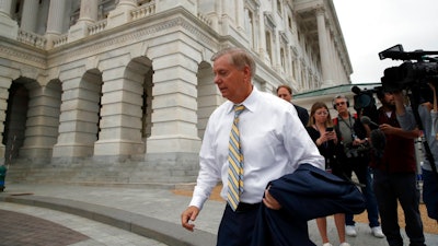 Sen. Lindsey Graham, R-S.C., departs after the confirmation vote of Supreme Court nominee Brett Kavanaugh, on Capitol Hill, Saturday, Oct. 6, 2018, in Washington. Kavanaugh was confirmed 50-48.