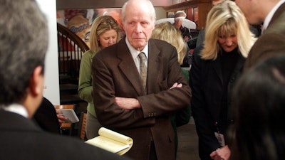 In this Tuesday, Feb. 1, 2005, file photo, William 'Bill' Coors, center, talks about the merger between Molson and Coors after a news conference at the Coors Brewery in Golden, Colo. Molson Coors Brewing Co. said that William 'Bill' Coors, the former chairman of Adolph Coors Co. and grandson of the brewing company's founder, died Saturday, Oct. 13, 2018, at age 102.