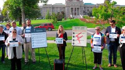 In this Aug. 22, 2018, file photo, Amanda Cahill of the American Heart Association speaks to a rally in support of a ballot initiative to raise Montana's tobacco taxes in Helena, Mont. Industry-funded opponents of Montana citizen's initiatives to raise the state's tobacco tax and add new mining regulations are vastly outspending the measures' supporters to put their messages in front of voters about a month before Election Day, according to campaign finance reports.