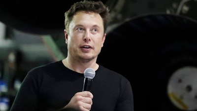 In this Sept. 17, 2018, file photo SpaceX founder and chief executive Elon Musk speaks after announcing Japanese billionaire Yusaku Maezawa as the first private passenger on a trip around the moon in Hawthorne, Calif. Tesla and its CEO Musk have agreed to pay a total of $40 million and make a series of concessions to settle a government lawsuit alleging Musk duped investors with misleading statements about a proposed buyout of the company. The Securities and Exchange Commission announced the settlement Saturday, Sept. 29, 2018, just two days after filing a case seeking to oust Musk as CEO.