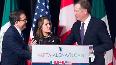 In this Jan. 29, 2018, file photo foreign Canadian Affairs Minister Chrystia Freeland, center, talks with United States Trade Representative Robert Lighthizer, right, and Mexico's Secretary of Economy Ildefonso Guajardo Villarreal after delivering statements to the media during the sixth round of negotiations for a new North American Free Trade Agreement in Montreal. The new United States-Mexico-Canada Agreement replaces the 24-year-old North American Free Trade Agreement, which tore down trade barriers between the three countries.