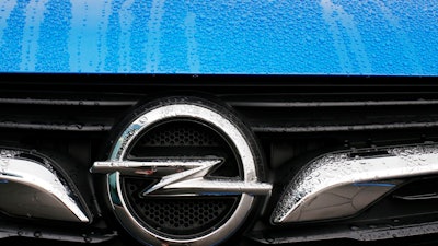 This Thursday, Nov. 9, 2017 file photo shows an Opel logo of an Opel Grandland at the Opel headquarters in Ruesselsheim, Germany. German prosecutors said Monday Oct. 15, 2018, that law enforcement officials have conducted searches at automaker Opel as part of an investigation into suspected manipulation of diesel emissions.