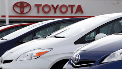 This Feb. 19, 2012, file photo shows a line of 2012 Prius sedans at a Toyota dealership in the south Denver suburb of Littleton, Colo. Toyota Motor Corp. said Friday, Oct. 5, 2018, it has issued a recall for 2.43 million hybrid vehicles in Japan and elsewhere for problems with stalling.