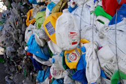 In this Thursday, Sept. 6, 2018, photo, bundled plastic goods, which were separated from paper and metal recyclable materials, are stacked and awaiting processing at EL Harvey & Sons, a waste and recycling company, in Westborough, Mass. Recycling programs across the United States are shutting down or scaling back because of a global market crisis blamed on contamination at the curbside bin.