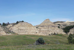 This file photo shows a view of the badlands landscape at Theodore Roosevelt National Park near Medora, N.D. Environmental groups opposing the site of an oil refinery being developed near Theodore Roosevelt National Park in North Dakota want a judge to reconsider his recent recommendation that state regulators dismiss the groups' challenge.