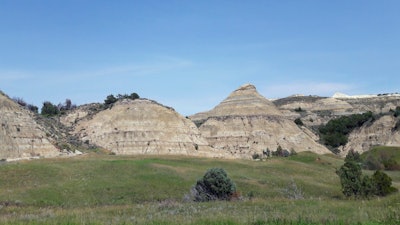 This file photo shows a view of the badlands landscape at Theodore Roosevelt National Park near Medora, N.D. Environmental groups opposing the site of an oil refinery being developed near Theodore Roosevelt National Park in North Dakota want a judge to reconsider his recent recommendation that state regulators dismiss the groups' challenge.