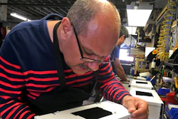 Former Iraqi refugee Majid Al Lessa works on a lighting fixture on the assembly floor of LiteLab, which employs refugees, Friday, Sept. 28, 2018, in Buffalo, N.Y. Thousands of refugees have settled in Buffalo in recent years even as others have left the city. Some locals worry that the Trump administration's policies reducing the numbers of new arrivals will harm the city's economy.
