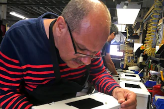 Former Iraqi refugee Majid Al Lessa works on a lighting fixture on the assembly floor of LiteLab, which employs refugees, Friday, Sept. 28, 2018, in Buffalo, N.Y. Thousands of refugees have settled in Buffalo in recent years even as others have left the city. Some locals worry that the Trump administration's policies reducing the numbers of new arrivals will harm the city's economy.