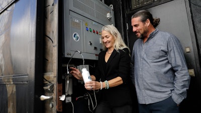 The Skysource/Skywater Alliance co-founders David Hertz, right, and his wife Laura Doss-Hertz demonstrate how the Skywater 300 works Wednesday, Oct. 24, 2018, in Los Angeles. The company received the $1.5 million XPrize For Water Abundance for developing the Skywater 300, a machine that makes water from air.