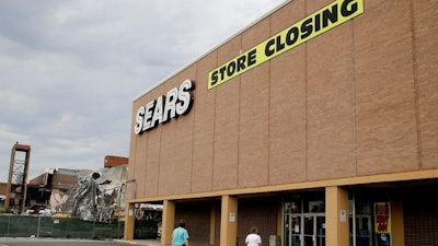 n this July 8, 2017, file photo people walk into a Sears store slated for closing that is next to a mall that is being torn down in Overland Park, Kan. Sears has filed for Chapter 11 bankruptcy protection Monday, Oct. 15, 2018, buckling under its massive debt load and staggering losses. The company once dominated the American landscape, but whether a smaller Sears can be viable remains in question.