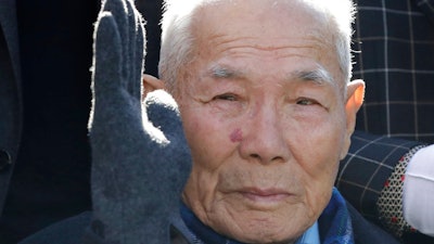 South Korean Lee Chun-sik, a 94-year-old victim of forced labor during Japan's colonial rule of the Korean Peninsula before the end of World War II, gestures upon his arrival at the Supreme Court in Seoul, South Korea, Tuesday, Oct. 30, 2018. In a potentially far-reaching decision, South Korea's Supreme Court ruled that a Japanese steelmaker should compensate four South Koreans for forced labor during Japan's colonial rule of the Korean Peninsula before the end of World War II.