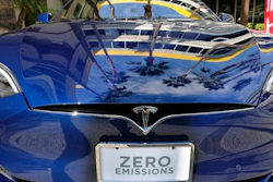 In this Oct. 24, 2016, file photo, palm trees are reflected on the hood of a Tesla Model S on display in downtown Los Angeles. Tesla says it recorded one accident for every 3.34 million miles driven when the autopilot was engaged. That number of per-mile accidents rises to 1.92 million when autopilot is not on.
