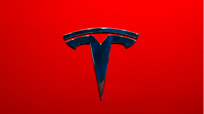 This Oct. 3, 2018, file photo shows the logo of Tesla model 3 at the Auto show in Paris. Tesla Inc. reports earnings on Wednesday, Oct. 24.
