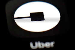 This March 20, 2018, file photo shows the Uber app on an iPad in Baltimore. Uber may put forth an initial public offering early next year that values the ride-hailing business at as much as $120 billion, according to a media report. The Wall Street Journal said Tuesday, Oct. 16, that Uber Technologies Inc. received valuation proposals from Goldman Sachs and Morgan Stanley.