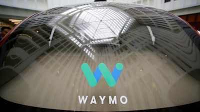In this Dec. 13, 2016, file photo, a skylight is reflected in the rear window of a Waymo driverless car during a Google event in San Francisco. Arizona will be home to a sprawling facility for researching the safety of self-driving cars, cementing the state's determination to invest in the technology. Gov. Doug Ducey signed an executive order Thursday, Oct. 11, 2018, establishing the newly-created Institute for Automated Mobility.