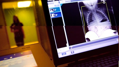 In this Feb. 9, 2018, file photo, a radiology technician looks at a chest X-ray of a child suffering from flu symptoms at Upson Regional Medical Center in Thomaston, Ga. The Trump administration is quietly trying to weaken radiation rules, relying on scientific outliers who argue that a little radiation damage is actually good for you - like a little bit of sunlight.