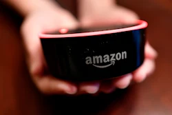 In this Aug. 16, 2018, file photo a child holds his Amazon Echo Dot in Kennesaw, Ga. Amazon.com Inc. reports earnings Thursday, Oct. 25.